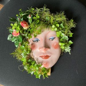 Hanging face sculpture